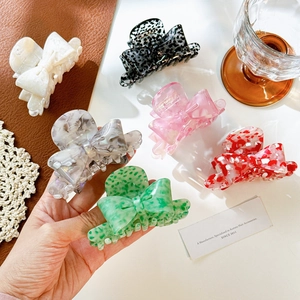 Elegant acetate bow hair claws in six colors including leopard and floral patterns