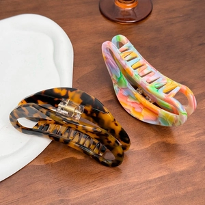Large acetate claw clips in tortoiseshell and marble patterns for thick hair styling