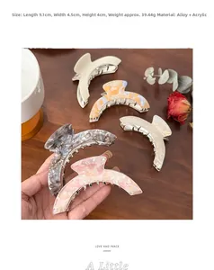 Detail view of large marble texture hair claw clip showing precise size 9.1cm length