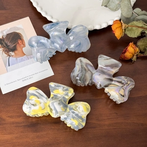 Set of large acetate bow hair claws with marble texture in blue, purple and white