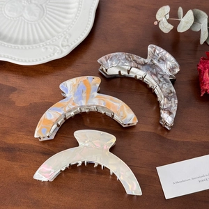 Polished acetate arched large hair claw clips in marble and pearlescent patterns