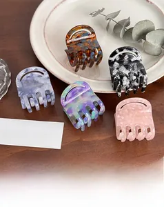 French style acetate claw clips in five colors displayed on a white plate with dry flowers