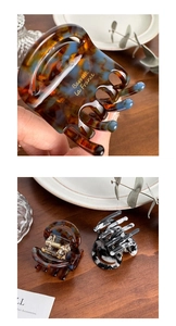 Macro detail of acetate claw clips in tortoiseshell and marble patterns with gold lettering