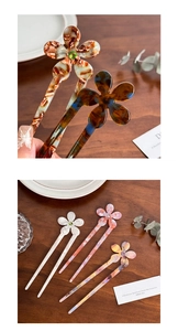 Detail view of floral acetate hair pin with U-shaped design and rhinestone center accents