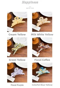 Showcase of six acetate bow hair claws in various patterns on a wooden tabletop