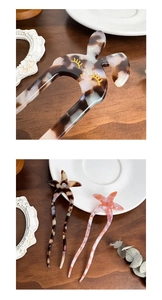 Close-up of tortoise shell acetate hair pins with rabbit and star shapes and pearls