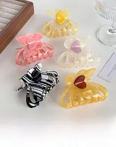 Detailed set of five medium butterfly hair claws in assorted acetate colors and patterns