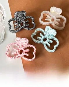 Set of four acetate hollow bow claw clips in floral, leopard, and pearl white patterns