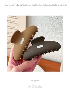 Close-up of 10cm matte resin shark hair clips in brown tones with size measurements