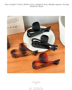 Detailed size view of resin shark hair clips in black and tortoiseshell amber colors