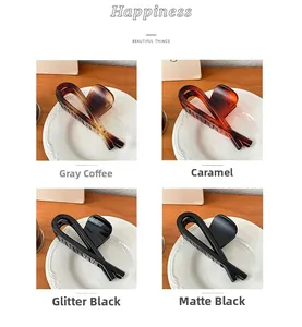 Detail showing four styles of large hair claws in matte black, caramel, and gradient colors