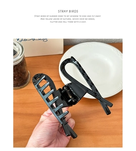 Detail view of large black minimalist hair claw clip with sleek geometric hollow design