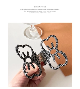 Macro detail of the acetate butterfly hair claw with black and white marble patterns