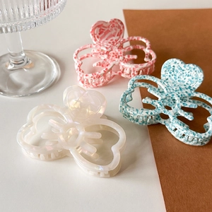 Three-piece acetate hair claw clips with bow shape and floral patterns for women's hairstyle