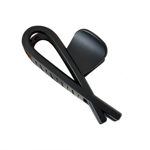 Minimalist matte black shark hair claw clip with streamlined crisscross design for women