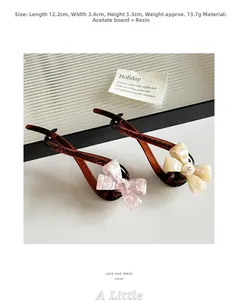 Detailed view of acetic acid bow hair clip with rhinestone and dimensions 12.2x3.4cm