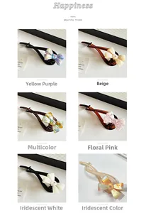 Detail view of colorful bow-knot banana clips with marble texture and rhinestone accents