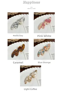 Detailed close-up showing five acetate hair clips with unique marble textures and colors