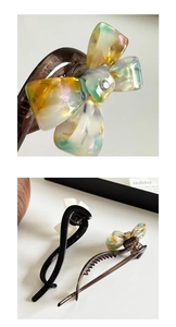 Detailed macro view of the acetate bow hair claw with colorful resin swirl and rhinestone