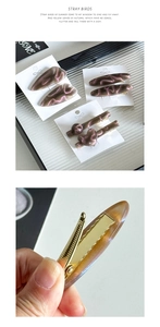 Detailed macro view of vintage acetate duckbill hair clips with marble texture