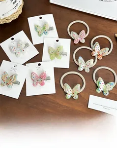 Detailed close-up of acetate butterfly hair clips and ties with colorful rhinestones