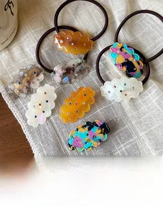 Detail of 7-piece wave hair clips and ties set with colorful rhinestones on linen
