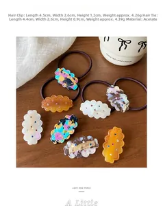 Macro detail of cloud-shaped acetate hair clips with colorful rhinestones on wood