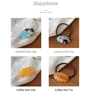 Close-up of cloud-shaped hair clips and hair ties with colorful rhinestones in acrylic