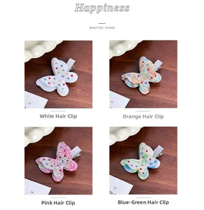Detailed close-up of butterfly hair clips with colorful rhinestones in four vibrant colors