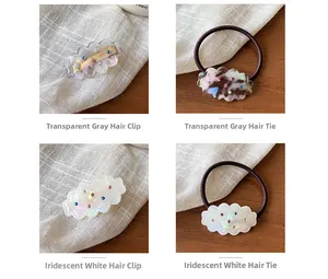 Detail of cloud-shaped hair clip and elastic band with colorful rhinestones on acrylic
