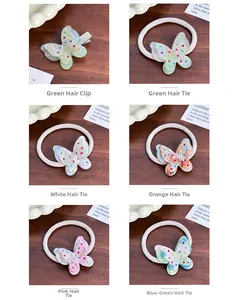 Detailed grid of butterfly hair clips and elastic bands with rhinestones on wood texture
