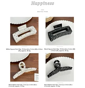 Detailed view of black and white polka dot hair claws with dimensions and weight specs