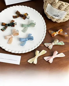Detailed collection of colorful acetate bow hair clips with marble and pearly textures