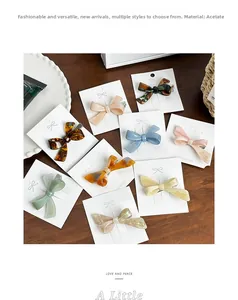 Detail of acetate bow hair clips in various colors with metal spring fasteners