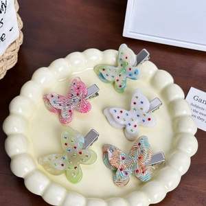 Five-piece butterfly hair clip set with sparkling rhinestones in assorted vibrant colors