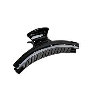 Polished black hair claw clip with white polka dots for elegant hair styling