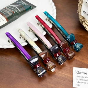 Handmade acetate bow hair clips set in purple, white, pink, red, and blue colors