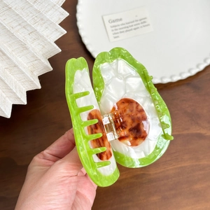 Large avocado-shaped acetate hair claw clip with glossy green finish and marble texture