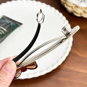 Elegant tortoise shell resin bow hair clip with silver spring metal fastener for women