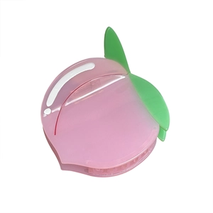 Pink peach shaped acetate hair claw clip with green leaf detail on a white background