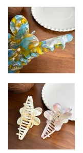 Detailed macro view of acetate butterfly hair claw clips with sparkling rhinestones decoration