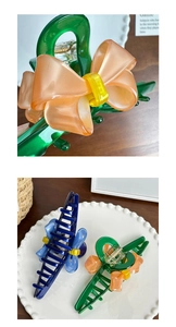 Macro detail of high-quality large acetate hair claw clip with colorful bowknot design