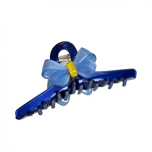 Minimalist blue acetate bow hair claw clip with yellow contrast center for elegant styling