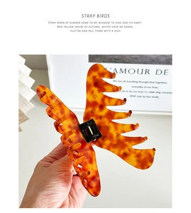 Detail of large tortoiseshell acetate hair claw clip showing glossy finish and strong grip
