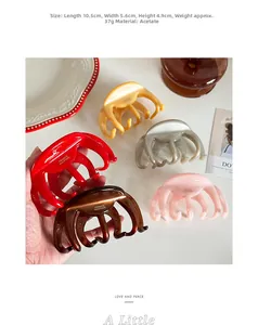 Detail view of 10.5cm acetate hair claws in various colors with handmade mark