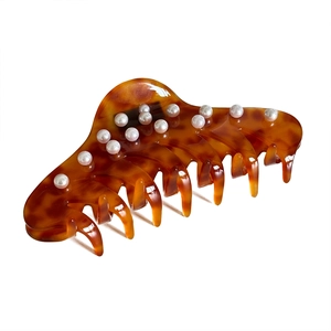 Large amber tortoiseshell acetate hair claw clip decorated with white pearls for women