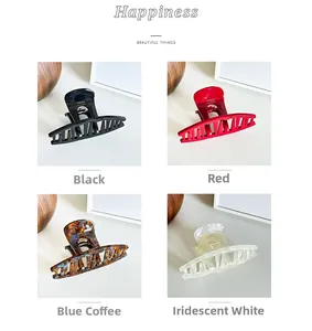Detail view of acetate hair claws in black, red, tortoise shell, and pearl white colors