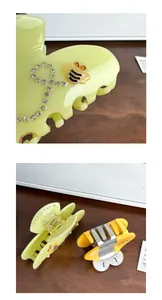 Detailed macro view of acetate bee hair claw with rhinestones and orange butterfly clip