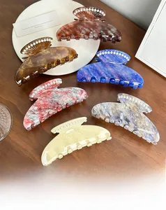 Close-up of assorted acetate shell hair claws with elegant pearl embellishments
