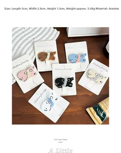 Detailed size view of six assorted dog-shaped acetate hair clips on a card